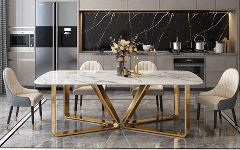 A marble dining table with a gold base
