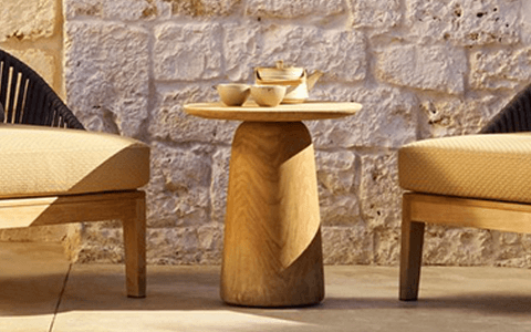 a sculptural wood side table for modern outdoor seating